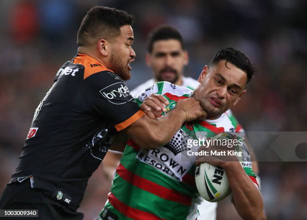 John Sutton of the Rabbitohs is tackled during the round 19 NRL match between the Wests Tigers and the South Sydney Rabbitohs at ANZ Stadium on July...