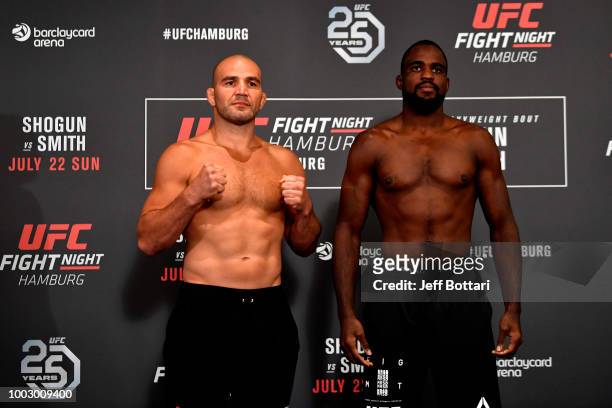 Opponents Glover Teixeira of Brazil and Corey Anderson pose for the media during the UFC Fight Night Weigh-in event at the Radisson Blu Hotel on July...