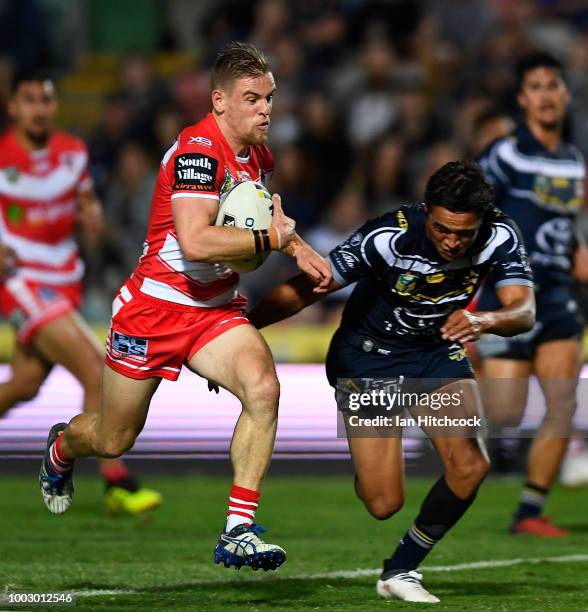 Matt Dufty of the Dragons makes a break which lead to him scoring a try during the round 19 NRL match between the North Queensland Cowboys and the St...