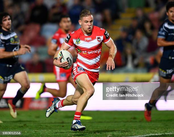 Matt Dufty of the Dragons makes a break which lead to him scoring a try during the round 19 NRL match between the North Queensland Cowboys and the St...