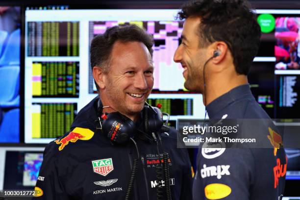 Red Bull Racing Team Principal Christian Horner talks with Daniel Ricciardo of Australia and Red Bull Racing in the garage during final practice for...