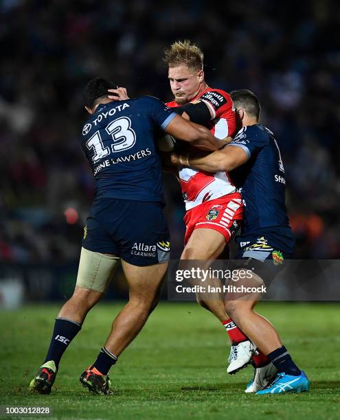 Jack de Belin of the Dragons is tackled during the round 19 NRL match between the North Queensland Cowboys and the St George Illawarra Dragons at...