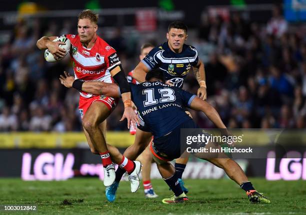 Jack de Belin of the Dragons is tackled by Jason Taumalolo of the Cowboys during the round 19 NRL match between the North Queensland Cowboys and the...