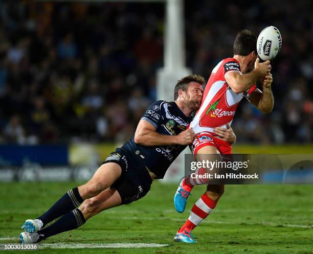 Ben Hunt of the Dragons is tackled by Gavin Cooper of the Cowboys during the round 19 NRL match between the North Queensland Cowboys and the St...