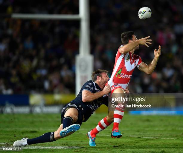 Ben Hunt of the Dragons is tackled by Gavin Cooper of the Cowboys during the round 19 NRL match between the North Queensland Cowboys and the St...