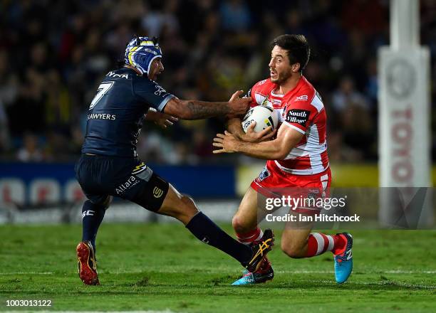 Ben Hunt of the Dragons is tackled by Johnathan Thurston of the Cowboys during the round 19 NRL match between the North Queensland Cowboys and the St...