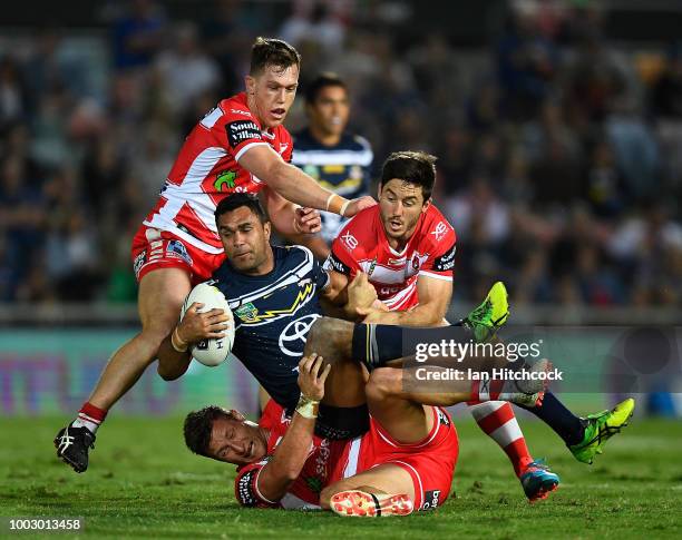 Justin O'Neil of the Cowboys is wrapped up by the Dragons defence during the round 19 NRL match between the North Queensland Cowboys and the St...