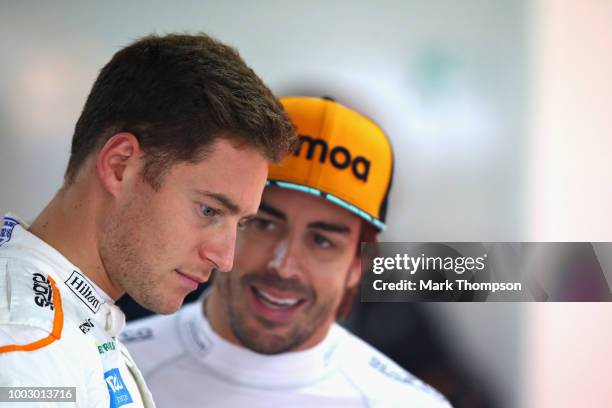 Stoffel Vandoorne of Belgium and McLaren F1 talks with Fernando Alonso of Spain and McLaren F1 in the garage during final practice for the Formula...