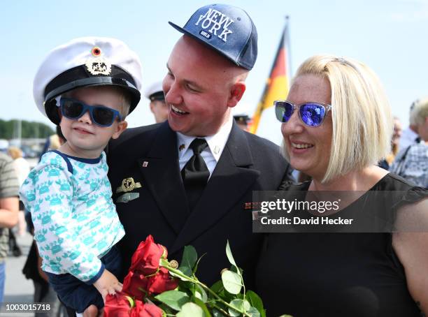 Petty officer second class Reno Ahrens with his son Luis and wife Doreen aboard the Bundeswehr Navy frigate "Hessen" upon its return to port on July...