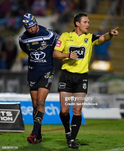 Johnathan Thurston of the Cowboys is seen holding his back after being injured during the round 19 NRL match between the North Queensland Cowboys and...