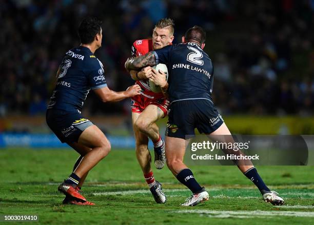 Matt Dufty of the Dragons is tackled by Kyle Feldt of the Cowboys during the round 19 NRL match between the North Queensland Cowboys and the St...