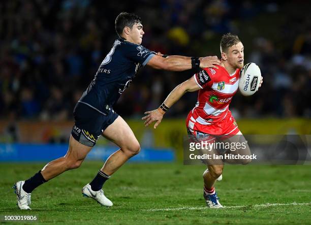 Matt Dufty of the Dragons is tackled by Jake Clifford of the Cowboys during the round 19 NRL match between the North Queensland Cowboys and the St...