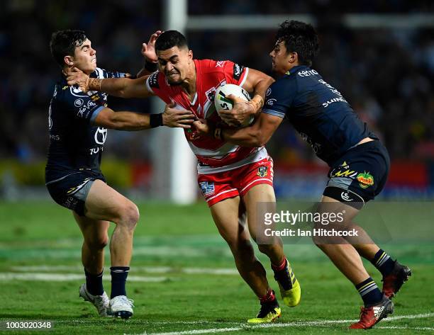 Tim Lafai of the Dragons is tackled by Enari Tuala of the Cowboys and Jake Clifford of the Cowboys during the round 19 NRL match between the North...