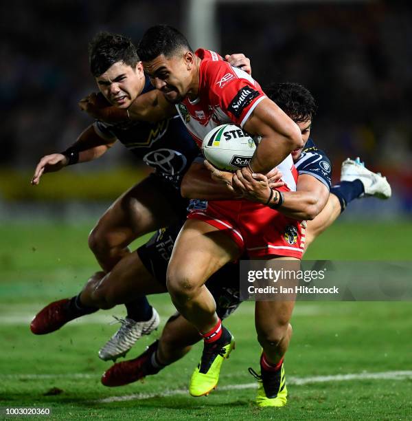 Tim Lafai of the Dragons is tackled by Enari Tuala of the Cowboys and Jake Clifford of the Cowboys during the round 19 NRL match between the North...