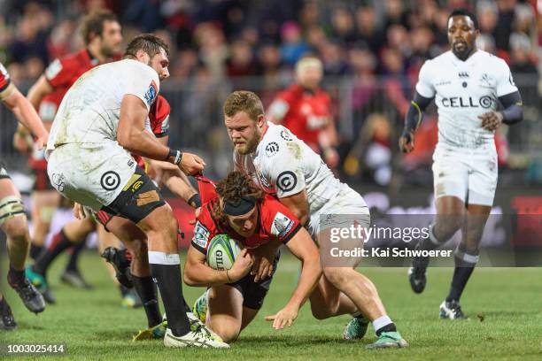 George Bridge of the Crusaders is tackled during the Super Rugby Qualifying Final match between the Crusaders and the Sharks at AMI Stadium on July...