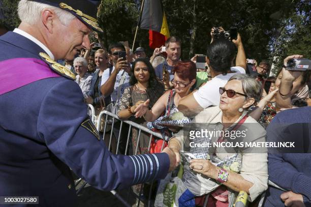King Philippe - Filip of Belgium shakes hands with a resident as he leaves the Te Deum mass, to mark the Belgium's National Day, at the Saint Michael...