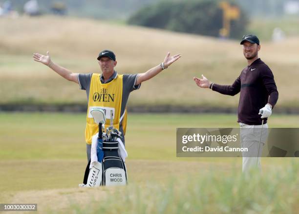 Chris Wood of England watches his second shot anxiously with his caddie Phil Moreby on the 18th hole after he nearly hit the shot out of bounds...