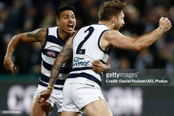 Tim Kelly of the Cats celebrates with Zach Tuohy of the Cats after winning the round 18 AFL match between the Geelong Cats and the Melbourne Demons...
