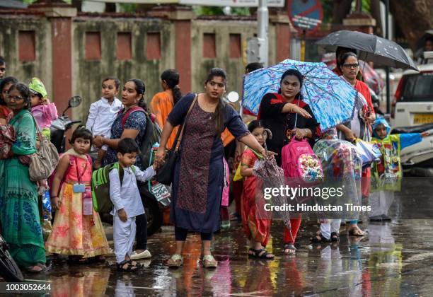 Parents with their kids waits outside for taxi due to school bus strike at IES Kindergarten at Dadar, on July 20, 2018 in Mumbai, India. The All...