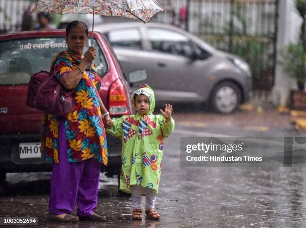 Parents with their kids waits outside for taxi due to school bus strike at IES Kindergarten at Dadar, on July 20, 2018 in Mumbai, India. The All...