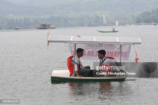 Kashmiri students of Chandigarh based Aryans Group of Colleges display a solar boat made by them for implementing the idea of solar-powered boats...
