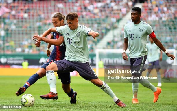 Jonathan Meier of Bayern Munich is tackled by Azzeddine Toufiqui of Paris Saint-German during the International Champions Cup 2018 match between...