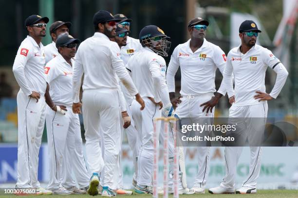 Sri Lankan cricket team members look on at the TV screen where Television Reviews are displayed during the 2nd day's play in the 2nd test cricket...