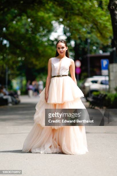 Model Cristina Comandari wears a beige and white lace mesh ruffled wedding dress from Cindyalan, during Feeric Fashion Week 2018, on July 21, 2018 in...