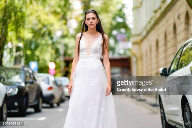 Model wears a white lace mesh wedding dress, during Feeric Fashion Week 2018, on July 21, 2018 in Sibiu, Romania.