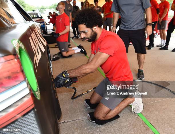 Mohamed Salah of Liverpool changing tyres during a tour of Roush Fenway Racing on July 21, 2018 in Charlotte, North Carolina.