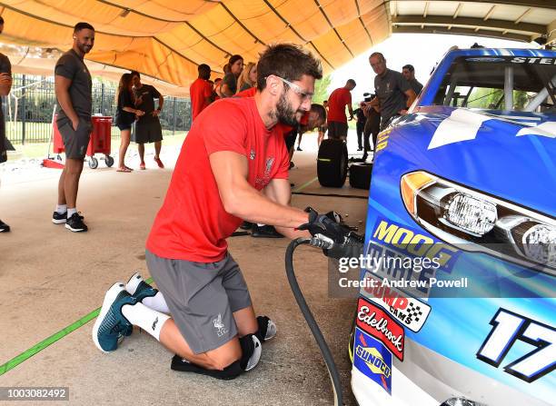 Adam Lallana of Liverpool changing tyres during a tour of Roush Fenway Racing on July 21, 2018 in Charlotte, North Carolina.