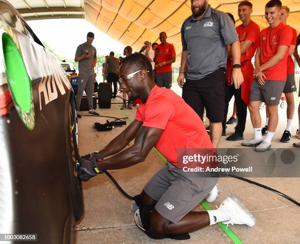 Naby Keita of Liverpool changing tyres during a tour of Roush Fenway Racing on July 21, 2018 in Charlotte, North Carolina.