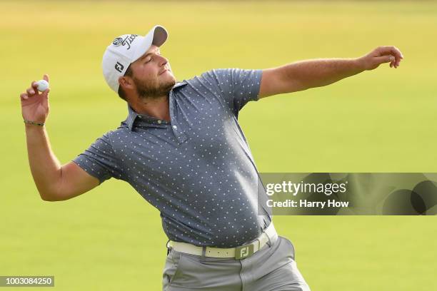 Zander Lombard of South Africa throws the ball into the crowd after his eagle on the 18th hole during the third round of the 147th Open Championship...