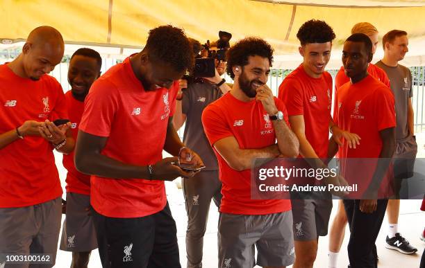 Mohamed Salah of Liverpool laughing as players change tyres during a tour of Roush Fenway Racing on July 21, 2018 in Charlotte, North Carolina.