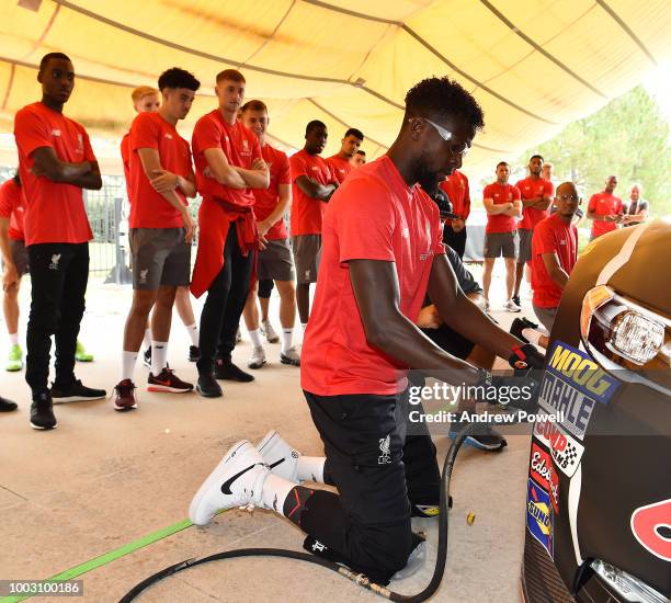 Divock Origi of Liverpool changing tyres during the tour of Roush Fenway Racing on July 21, 2018 in Charlotte, North Carolina.