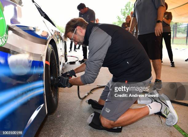 Jurgen Klopp manager of Liverpool changing tyres during a tour of Roush Fenway Racing on July 21, 2018 in Charlotte, North Carolina.