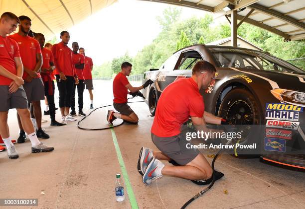 James Milner of Liverpool changing tyres during a tour of Roush Fenway Racing on July 21, 2018 in Charlotte, North Carolina.