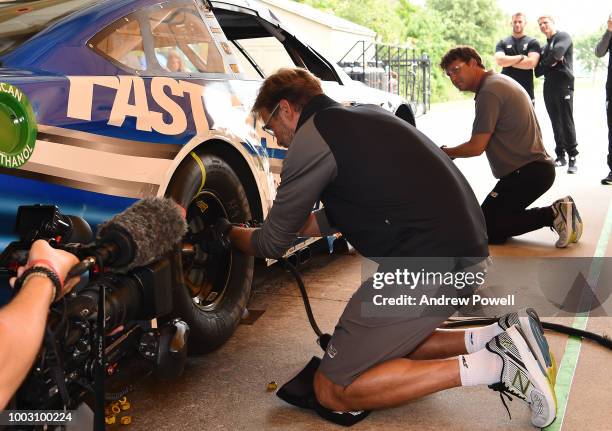 Jurgen Klopp manager of Liverpool changing tyres during a tour of Roush Fenway Racing on July 21, 2018 in Charlotte, North Carolina.