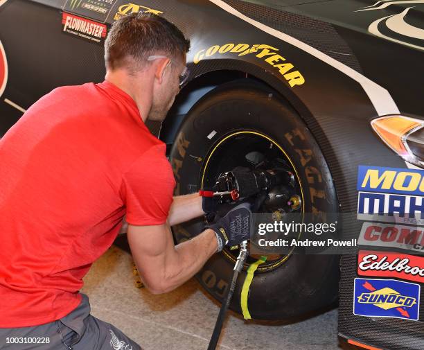 James Milner of Liverpool changing tyres during a tour of Roush Fenway Racing on July 21, 2018 in Charlotte, North Carolina.