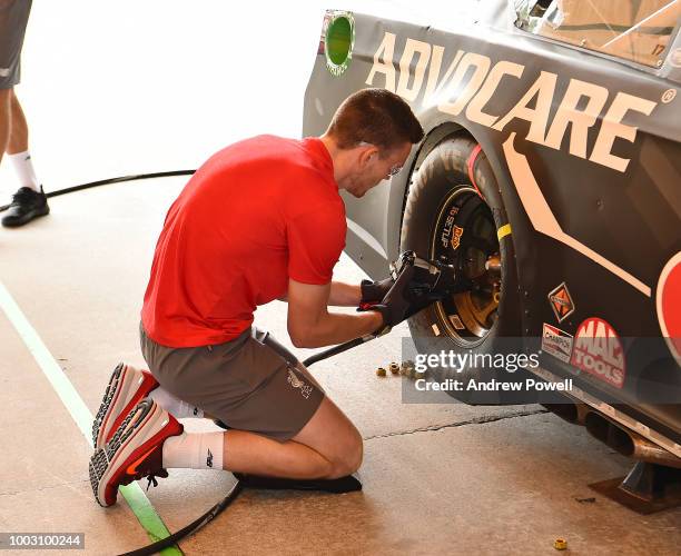 Andrew Robertson of Liverpool changing tyres during a tour of Roush Fenway Racing on July 21, 2018 in Charlotte, North Carolina.
