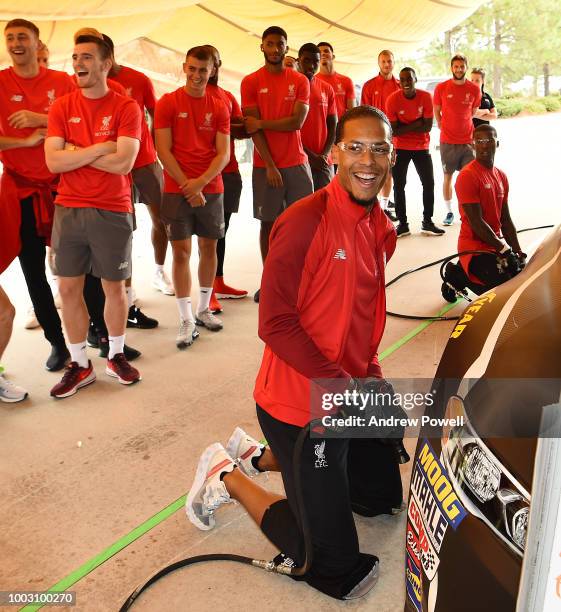 Virgil van Dijk of Liverpool changing tyres during a tour of Roush Fenway Racing on July 21, 2018 in Charlotte, North Carolina.