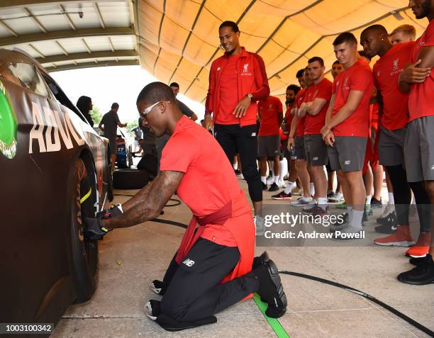 Georginio Wijnaldum of Liverpool changing tyres during a tour of Roush Fenway Racing on July 21, 2018 in Charlotte, North Carolina.