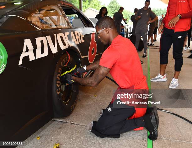 Georginio Wijnaldum of Liverpool changing tyres during a tour of Roush Fenway Racing on July 21, 2018 in Charlotte, North Carolina.