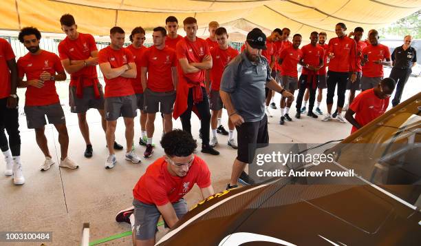 Liverpool players watch as Curtis Jones of Liverpool changes tyres during a tour of Roush Fenway Racing on July 21, 2018 in Charlotte, North Carolina.