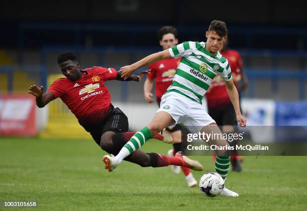 Aliou Traore of Manchester United and Wallace Duffy of Celtic during the u19 NI Super Cup gala match at Coleraine Showgrounds on July 21, 2018 in...