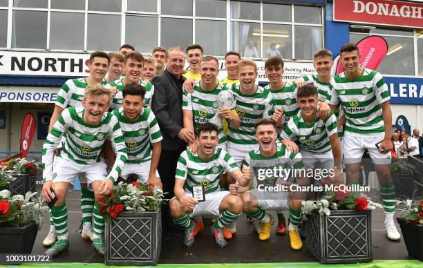 Celtic are presented with the trophy by Gerry Armstrong following the u19 NI Super Cup gala match at Coleraine Showgrounds on July 21, 2018 in...