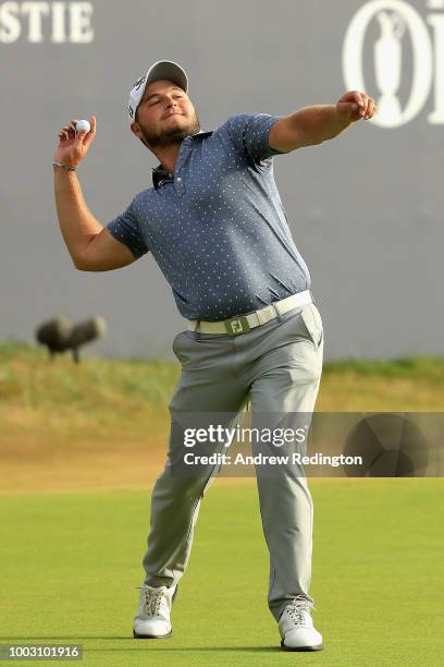 Zander Lombard of South Africa throws the ball into the crowd after his eagle on the 18th hole during the third round of the 147th Open Championship...