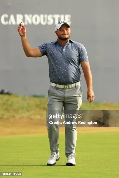 Zander Lombard of South Africa acknowledges the crowd after his eagle on the 18th hole during the third round of the 147th Open Championship at...