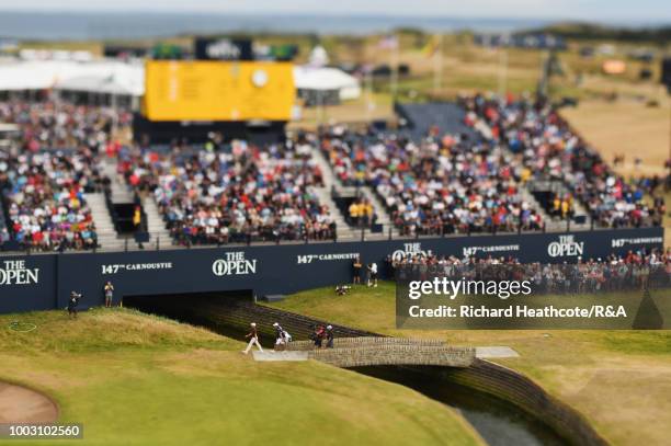 Rory McIlroy of Northern Ireland crosses the bridge over the Barry Burn towards the 18th hole green during round three of the Open Championship at...
