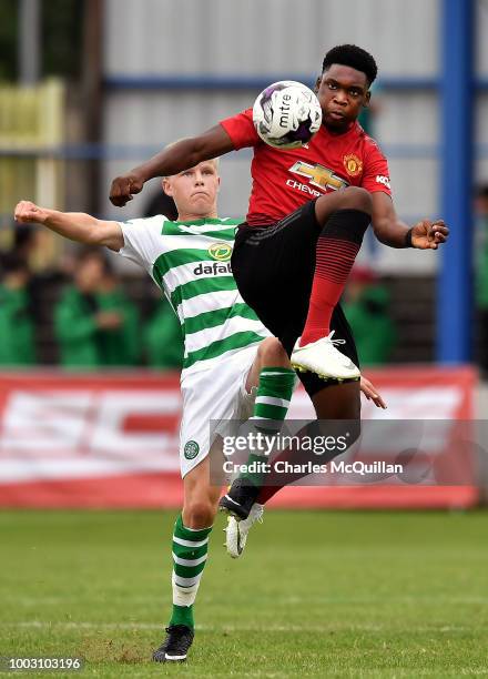 Teden Mengi of Manchester United and Scott Robertson of Celtic during the u19 NI Super Cup gala match at Coleraine Showgrounds on July 21, 2018 in...